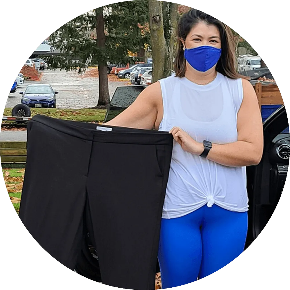 Before-After-8 - Woman holding oversized pants outdoors, showing weight loss