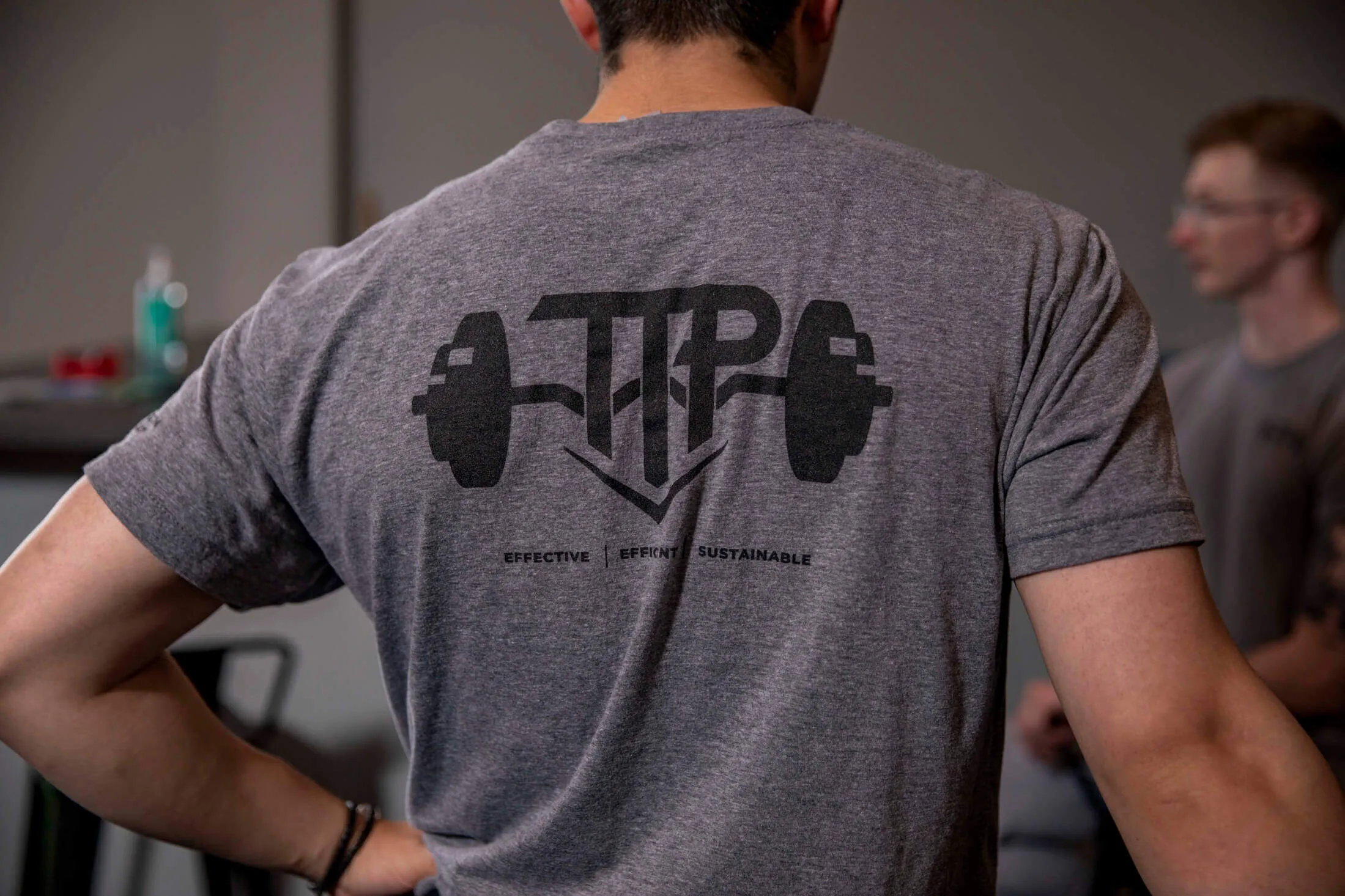 Fitness trainer with TTP shirt in a 1-on-1 personal training session